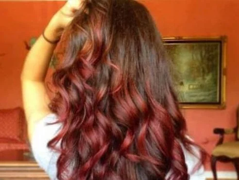 Light brown hair with burgundy highlights - subtle red wine tones