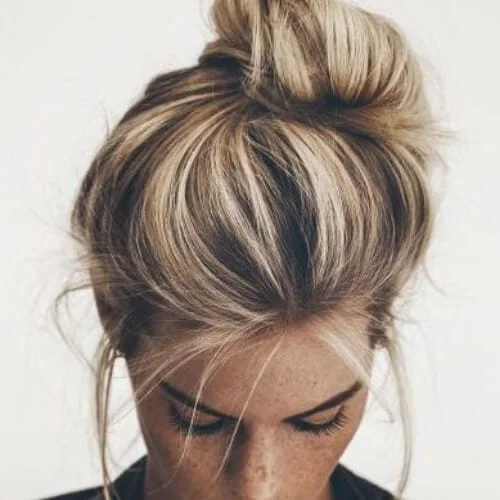 Elegant messy bun with brown hair and blonde highlights showing dimension