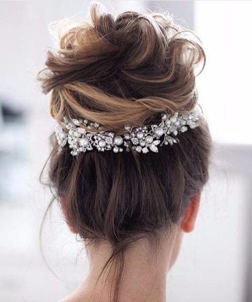 high textured messy bun with embellishments wedding hairstyles for long hair