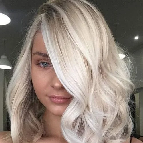 Shoulder length blonde lob with soft beach waves - modern platinum blonde styling