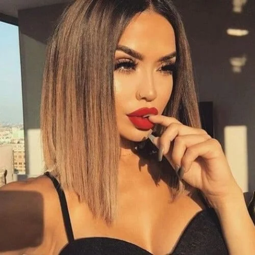 Shoulder-length A-line bob with ombre coloring from chocolate brown to blonde