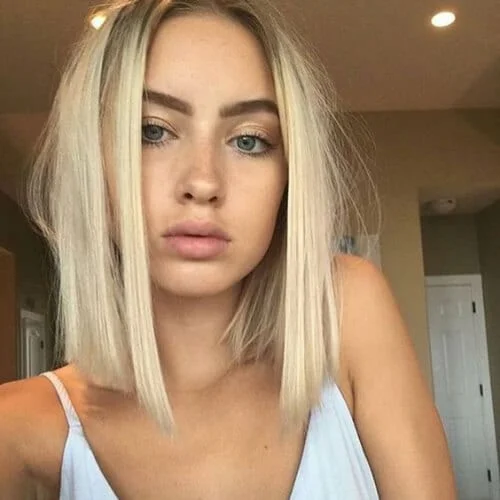 Woman with platinum blonde blunt bob haircut showcasing sleek straight hair styling