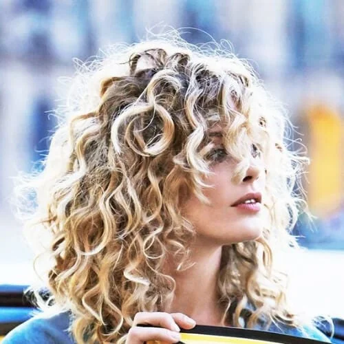 blonde curly hair with bangs