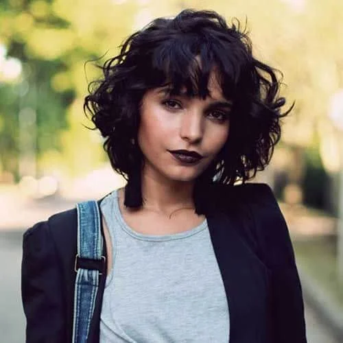 chic curly hair with bangs