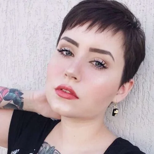 Boyish pixie cut with asymmetrical bangs perfect for minimalist straight hair styling
