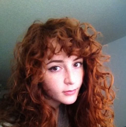 red hair curly hair with bangs