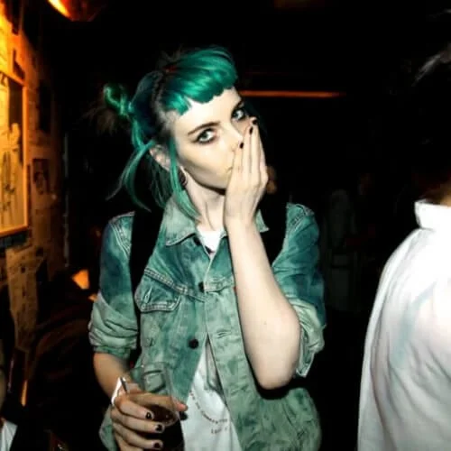 Short space buns punk hairstyle with colorful hair and creative styling - playful punk look