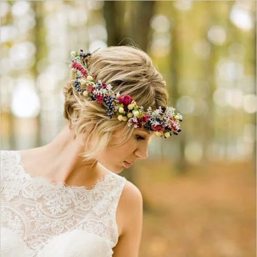 Asymmetrical short bob wedding hairstyles with natural flower crown - modern bridal hair ideas