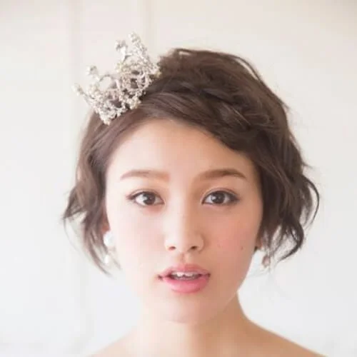 Princess wedding hairstyles for short hair with sparkly crown headpiece - elegant bridal accessories