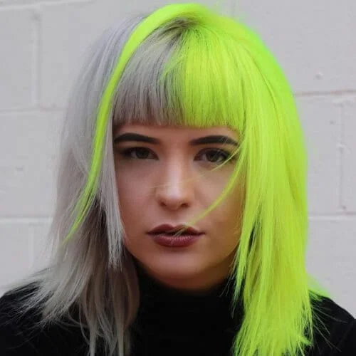 Silver and neon yellow two tone hair color with edgy metallic contrast - bold split dye transformation