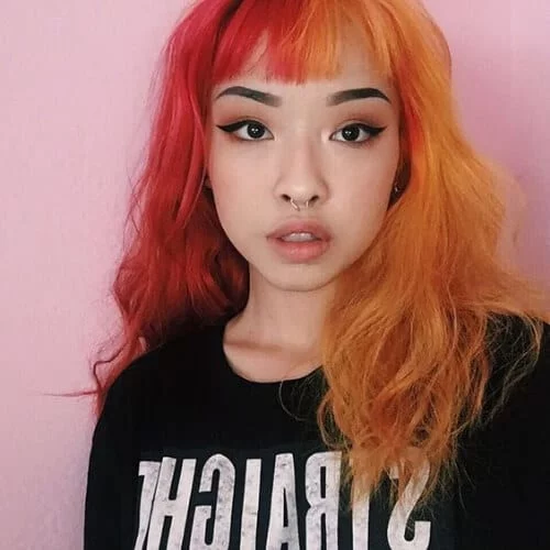 Tangerine and cherry red two tone hair color with fruit-inspired warm tones - vibrant split dye combination