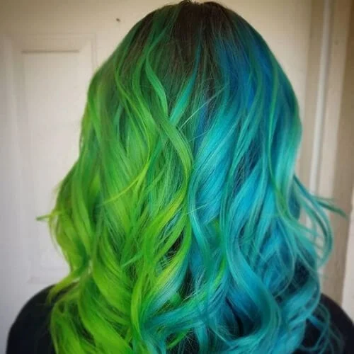 Toxic green and blue two tone hair color with superhero-inspired vibrant combination - bold split dye look
