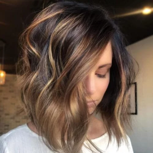 Disconnected long A-line bob with beach waves and caramel highlights - dimensional haircut for movement