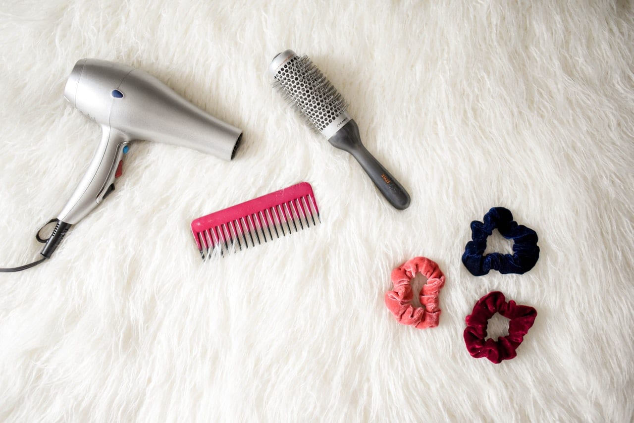 Blow dryer and comb on a white background