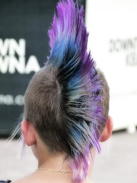 Back view of woman with elegant female mohawk featuring shaved sides and textured center strip - modern mohawk variation