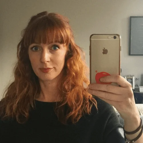 Curly Dark Strawberry Blonde Hair Color with Bangs