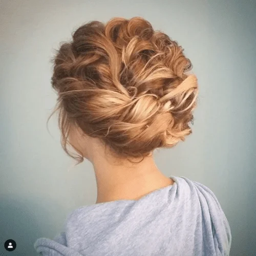Elegant low braided bun updo for short hair with subtle volume and texture