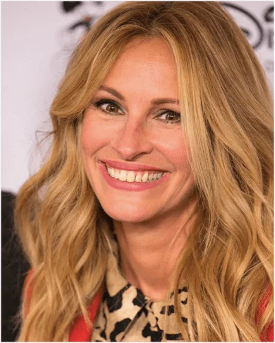 Julia Roberts with glamorous wavy strawberry blonde hair styled in loose curls