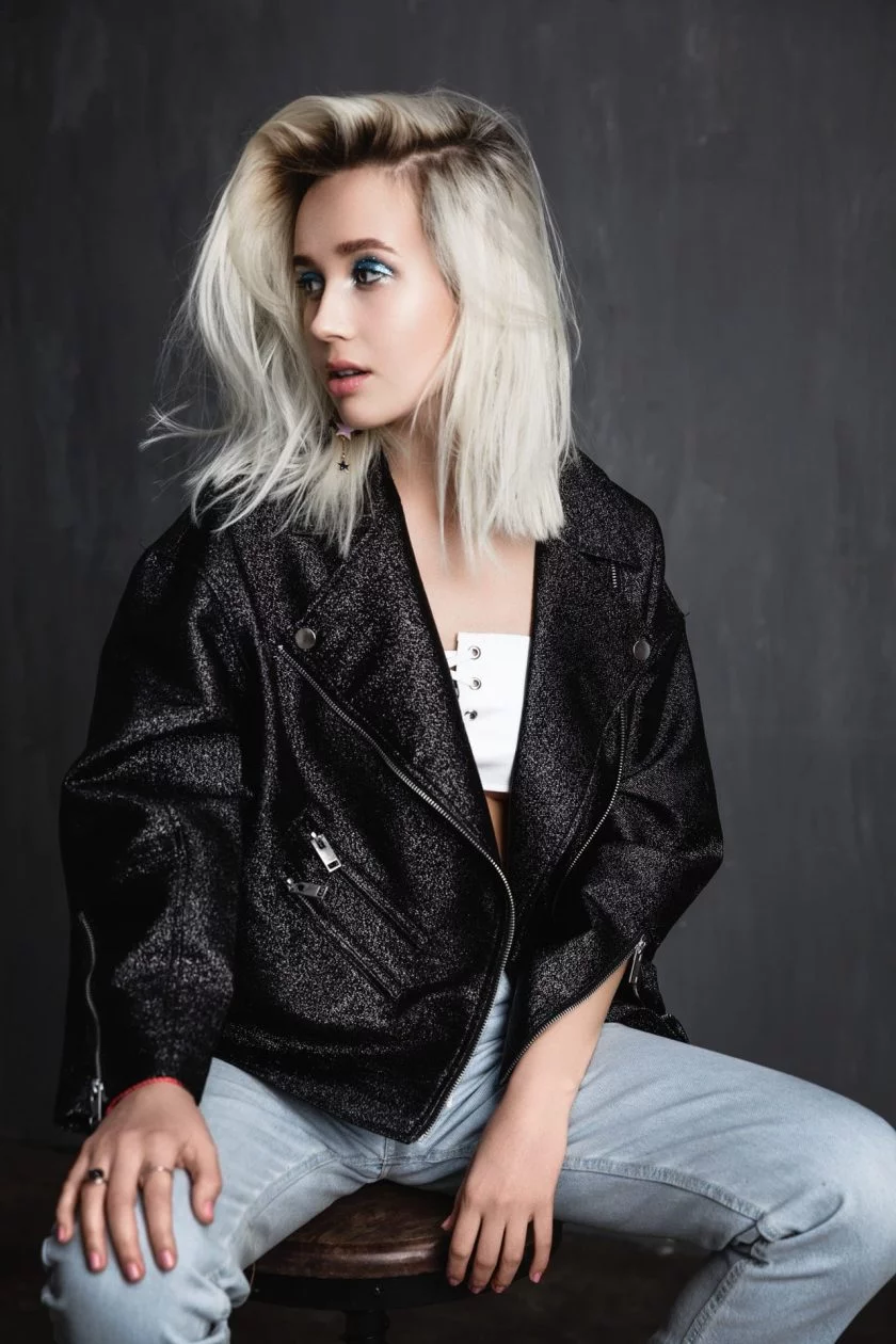 Blonde haired woman posing in chair