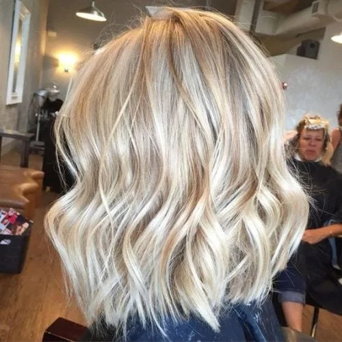 Bright blonde fall hair color with face-framing highlights