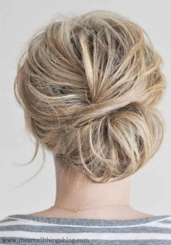 Messy low bun hairstyle for short hair showing how to create volume and texture with limited length