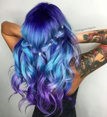 Blue and purple hair color combination with dark blue roots transitioning to purple tips