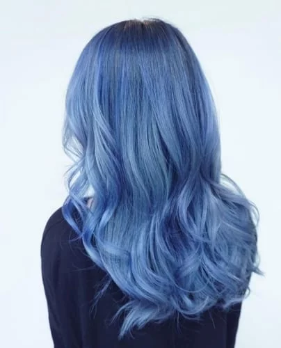 Blue gray ombre hair with defined curls enhancing the color transition