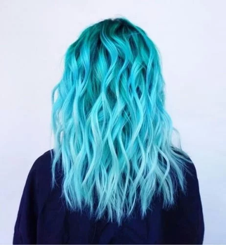 Mermaid-inspired blue hair with green accents and wavy texture creating an oceanic effect