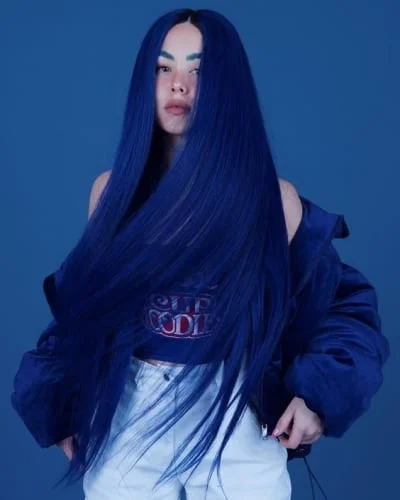 Vibrant electric blue hair with intense color saturation styled straight