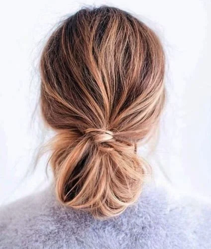 Elegant low bun Thanksgiving hairstyle with loosely wrapped hair - sophisticated holiday updo