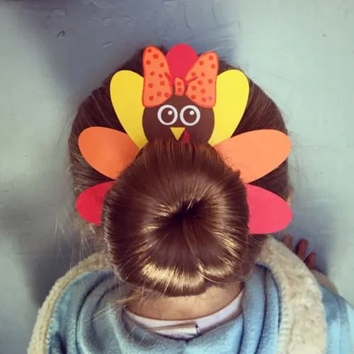 Adorable turkey bun Thanksgiving hairstyle for little girls - perfect for holiday celebrations