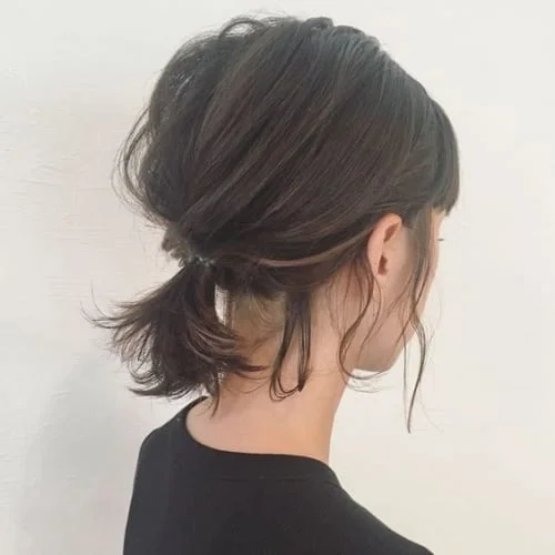 Low ponytail for short chin-length hair with choppy textured ends
