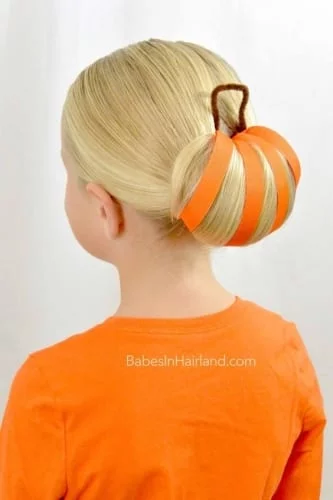 Creative pumpkin bun Thanksgiving hairstyle with orange ribbons - festive fall updo
