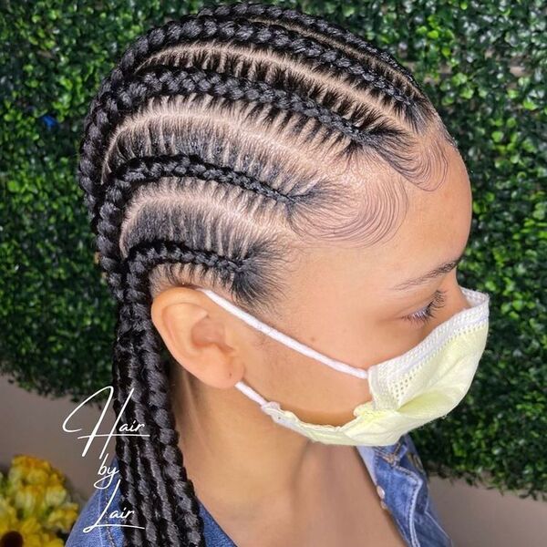 8 Feedin Braids with Curl ends - a woman wearing mask and denim top.