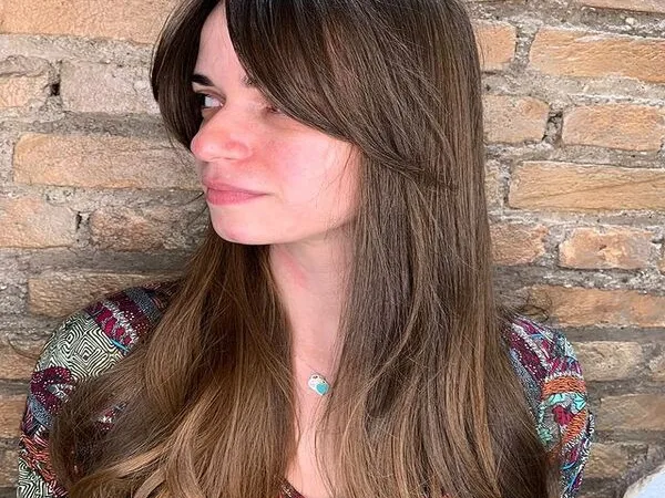 Beach Waves Curtain Hair - A woman wearing a necklace