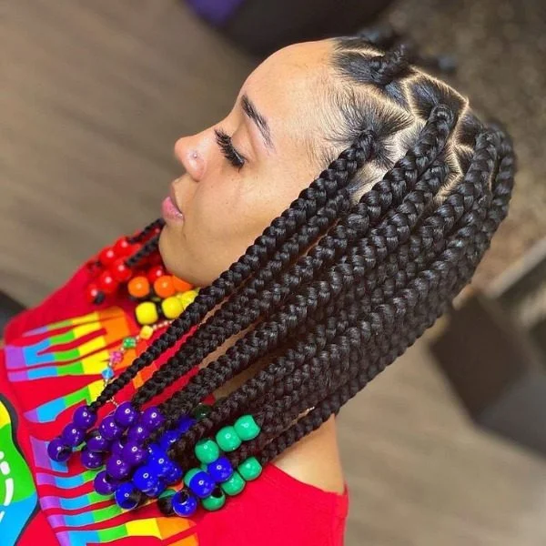 Big Box Lemonade Braids with Beads Hair - A woman wearing a red top