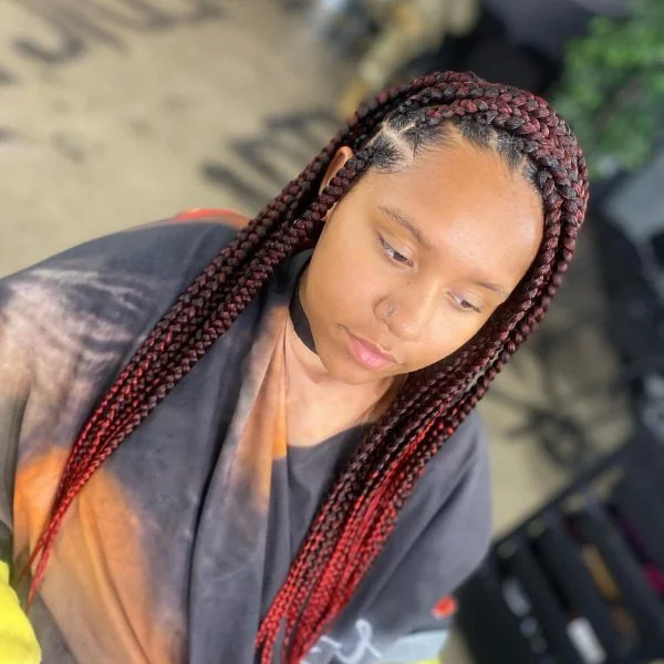 Crochet Lemonade Braided Hair - A woman wearing a salon cape