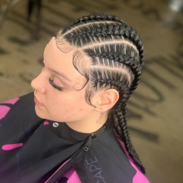Feed In Braided Hairstyle - A woman wearing a salon cape