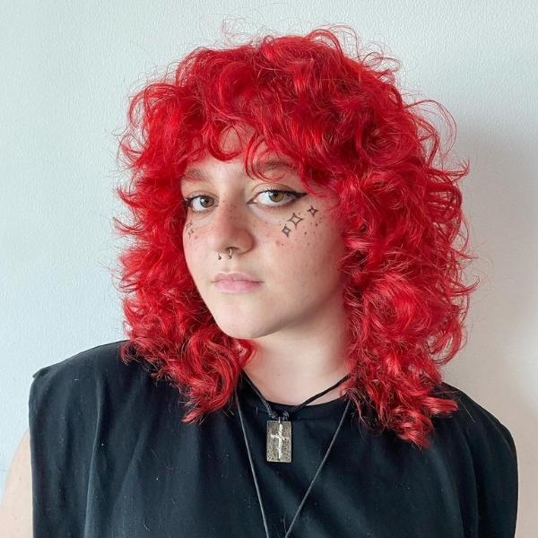 Fiery Red Curl Rings - A woman wearing a sleeveless black top