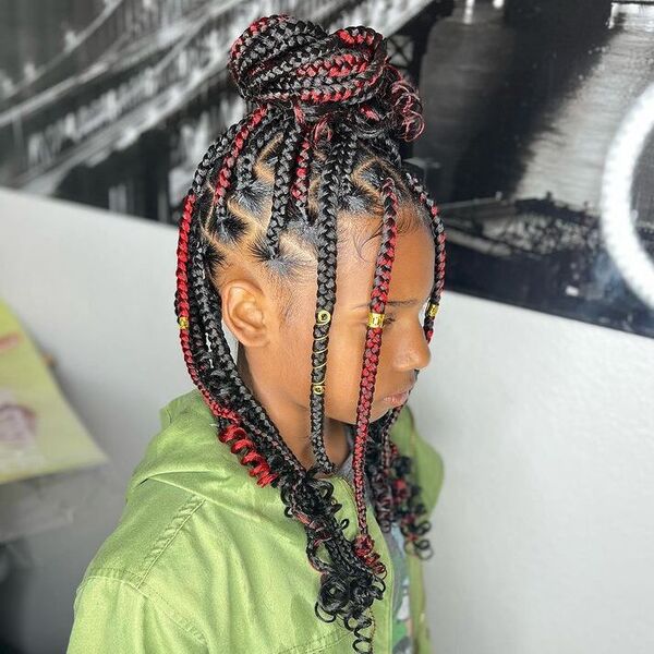 Knotless Braids in High Bun with Red Tints - a woman wearing green denim jacket.