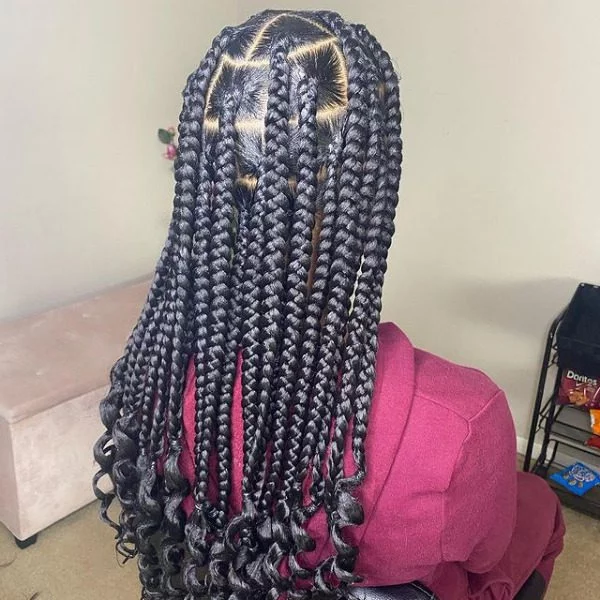 Knotless Lemon Weave Lemonade Braids - A woman wearing a maroon jacket