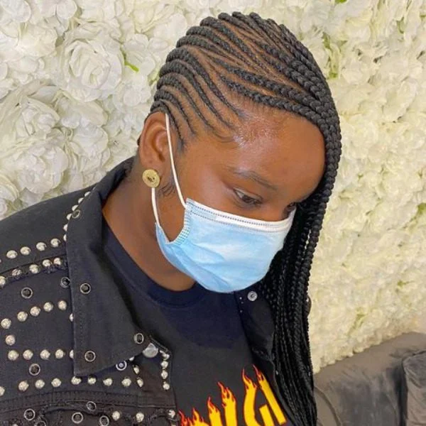 Lemonade Braided Hair - A woman wearing a surgical mask