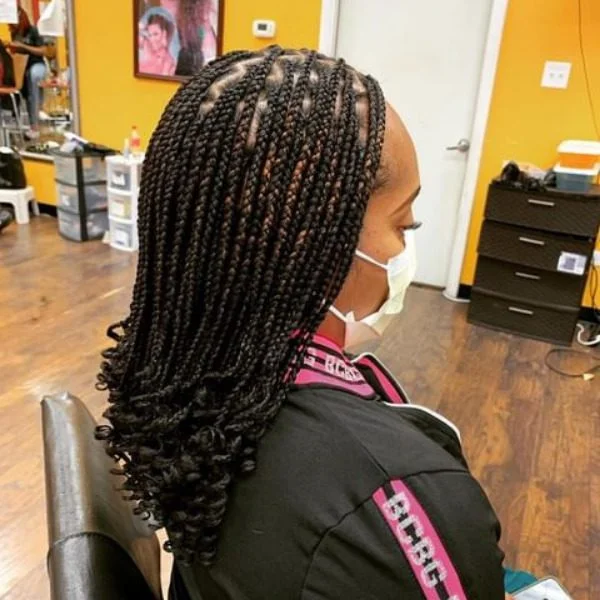 Lemonade Braids with Edge Curls Hair - A woman wearing a black jacket