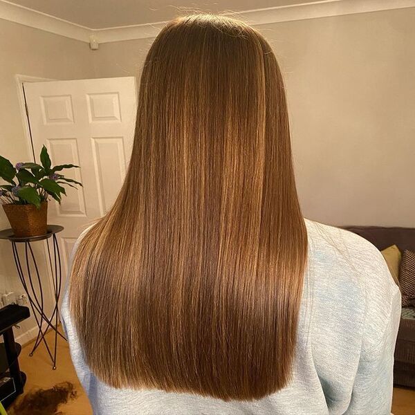 Light Brown with Soft Balayage Highlights - A woman wearing a grey jacket