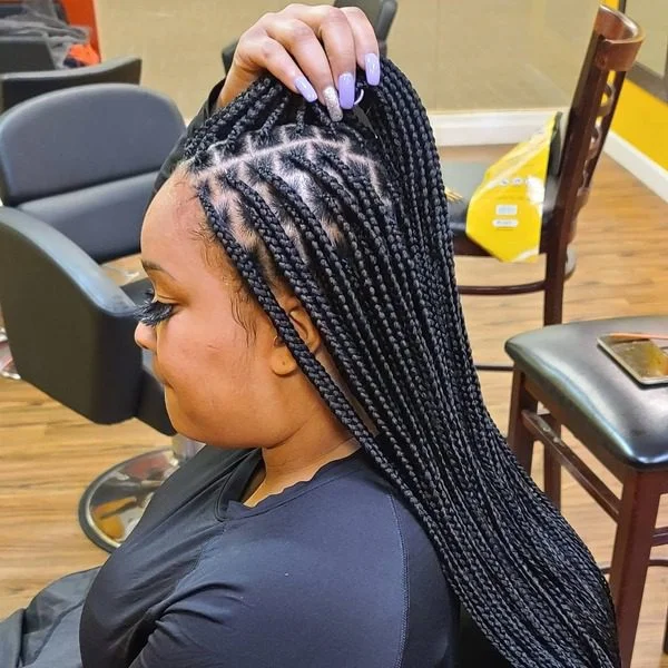 Long Knotless Braids - A woman wearing a black top