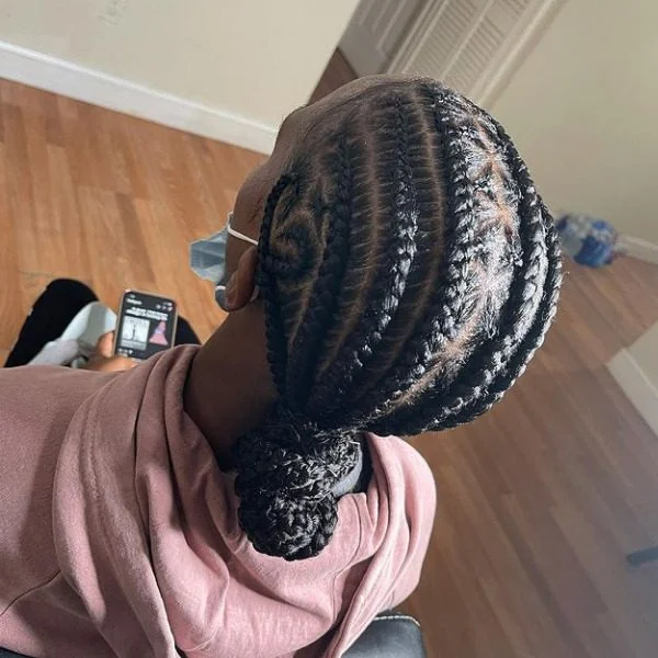 Low Bun Lemonade Braided Hair - A woman wearing a jacket