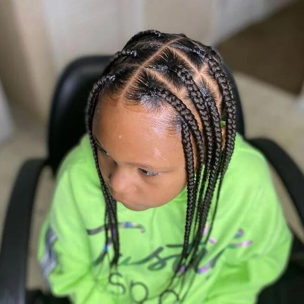 Medium Knotless Braids - a woman wearing a neon green sweater.