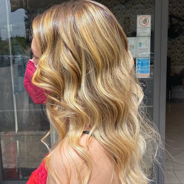 Medium Wavy Light Golden Brown Hair - A woman wearing a maroon mask