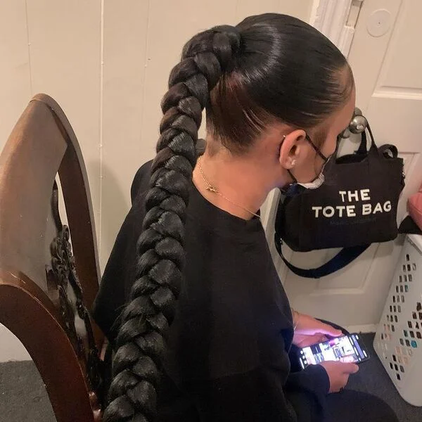 Neat Braids Ponytail - a woman wearing all black sweater and leggings.