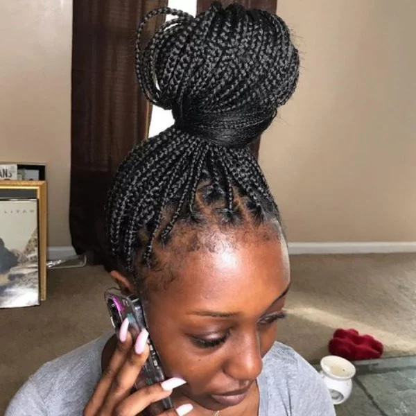 Top Knot Bun Knotless Lemonade Braided Hair - A woman wearing a grey top